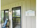 Charming entryway with 'Our Beach House' decor and a view of the scenic surroundings at 229 Linkside Villas # 1/3 Share, Edisto Beach, SC 29438