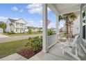 Charming front porch view with Adirondack chairs and a view of the street at 2383 Lenwick Hall Ln, Johns Island, SC 29455