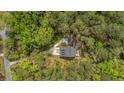 Aerial view of a private home with mature trees, a long driveway, and a manicured lawn at 2856 Claybrook St, Johns Island, SC 29455