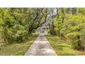 Beautiful two-story home with a long driveway, double garage, and inviting front porch surrounded by lush greenery at 2856 Claybrook St, Johns Island, SC 29455