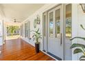 Inviting front porch featuring hardwood flooring and elegant architectural details at 301 Hidden Bottom Ln, Daniel Island, SC 29492