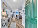 Bright entryway with stylish decor, wood floors, and a view into the living room with a fireplace at 311 Old Stone Ct, Moncks Corner, SC 29461