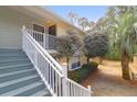 Close up of the exterior stairs leading to the front door, surrounded by mature trees at 341 W Coleman Blvd # F, Mount Pleasant, SC 29464
