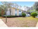 Residential building with a manicured lawn, tall palm trees, and classic architectural details on a sunny day at 341 W Coleman Blvd # F, Mount Pleasant, SC 29464