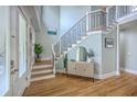 Elegant foyer with hardwood floors, staircase, and stylish decor at 3805 Adrian Way, Mount Pleasant, SC 29466