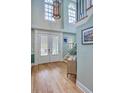 Grand foyer with hardwood floors, a staircase, chandelier, and lots of natural light at 3805 Adrian Way, Mount Pleasant, SC 29466