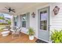 Inviting front porch with seating, stylish decor, and a ceiling fan, perfect for relaxation at 3873 Newhall St, Mount Pleasant, SC 29466