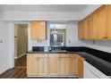 Kitchen with light wood cabinets, dark counters, and stainless steel sink at 404 Ventura Pl, Mount Pleasant, SC 29464