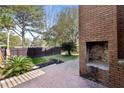Brick patio with outdoor fireplace and fenced yard at 404 Ventura Pl, Mount Pleasant, SC 29464