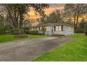 A single-story home with white painted brick, dark shutters, green lawn, and a concrete driveway at 5337 Hartford Cir, North Charleston, SC 29405