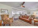 Inviting living room showcases hardwood floors, ceiling fan, and a leather couch with decorative pillows at 5337 Hartford Cir, North Charleston, SC 29405
