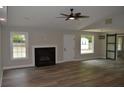 Spacious living room featuring a fireplace, wood-look flooring, and modern lighting at 708 Old State Rd, Goose Creek, SC 29445