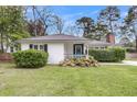 Charming single-story home with black shutters and a well-maintained lawn at 734 W Oak Forest Dr, Charleston, SC 29407