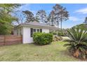 Single-story home with white siding, well-manicured lawn, and mature trees at 734 W Oak Forest Dr, Charleston, SC 29407