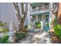 Beautifully landscaped yard and white home featuring double porches and a welcoming stone walkway at 78 Society St, Charleston, SC 29401
