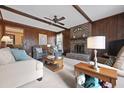Cozy living room with a brick fireplace, wood paneled walls, and comfortable seating at 8147 Waltham Rd, North Charleston, SC 29406