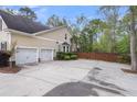 Large driveway with two car garage and side yard access at 8618 Mcchune Ct, North Charleston, SC 29420
