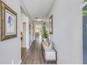 Long hallway with laminate flooring and decoratively framed art, leading to the living areas at 9703 Mosgrove Ave, Ladson, SC 29456