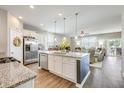 Open-concept kitchen featuring a large island, stainless steel appliances, and modern finishes at 9703 Mosgrove Ave, Ladson, SC 29456