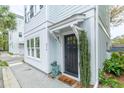 Inviting entryway featuring a dark front door, neatly landscaped greenery, and stylish decor at 975 Warrick Oaks Ln, Mount Pleasant, SC 29464