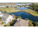 Aerial view of a waterfront community and golf course, with homes overlooking the picturesque lake at 1 Battery Park Rd, Edisto Island, SC 29438