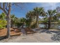 Beautifully landscaped grounds with mature palms, a fountain, and mulched beds with log borders at 1 Battery Park Rd, Edisto Island, SC 29438