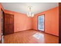 Dining room featuring wood floors, a window for light, and an elegant chandelier at 106 Egret Ln, Summerville, SC 29485