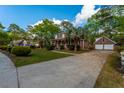 Spacious property featuring a lovely brick home with a detached two-car garage and an expansive driveway at 106 Egret Ln, Summerville, SC 29485