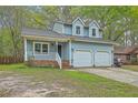 Charming two-story home with blue siding, double garage, and inviting front porch at 107 Lewisfield Dr, North Charleston, SC 29418