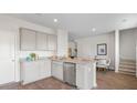 Open kitchen with stainless appliances, granite countertops, view of dining area and staircase at 107 River Hill Rd, Goose Creek, SC 29445
