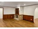 Cozy living room with wood paneled walls, a decorative fireplace, and hardwood floors at 1085 Russellville Rd, Saint Stephen, SC 29479