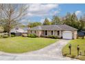 Well-maintained brick home featuring a spacious front yard and a curved driveway at 1109 Lee Shore Ln, Mount Pleasant, SC 29464