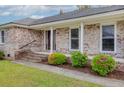Inviting entrance to a brick home, featuring colorful flowers and a well-kept lawn at 1109 Lee Shore Ln, Mount Pleasant, SC 29464