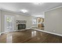 Cozy living room with hardwood floors, brick fireplace, and view of kitchen at 1109 Lee Shore Ln, Mount Pleasant, SC 29464