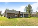 A spacious backyard featuring a brick house with a screened-in porch at 1144 Island View Dr, Mount Pleasant, SC 29464