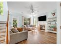 Comfortable living room features a fireplace, large windows, and ceiling fan at 119 Oakbluff Rd, Summerville, SC 29485