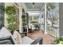 Relaxing covered porch with comfortable seating and views of the well-maintained front yard at 12 Leeann Ln, Mount Pleasant, SC 29464