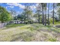 Expansive fenced yard showcasing a charming home and spacious grounds at 130 Oak Crest Dr, Moncks Corner, SC 29461
