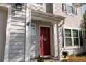 Close-up of a red front door with an anchor decoration and a 'Sweet Home' welcome mat at 1400 Harbor Mist Ct, Charleston, SC 29492