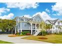 Attractive two-story home showcasing a spacious porch and professionally landscaped grounds at 1529 Tomato Farm Cir, Mount Pleasant, SC 29464