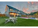 Spacious backyard featuring a fire pit, lounge chairs, and a shimmering pool ideal for enjoying outdoor living at 158 Garden Lily Ln, Summerville, SC 29485