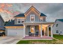 Charming two-story home boasts a welcoming front porch, attached garage, and beautiful curb appeal at 158 Garden Lily Ln, Summerville, SC 29485