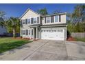 Well-maintained two-story home featuring an attached two car garage and beautifully landscaped front yard at 1909 Royal Empress Ct, Charleston, SC 29414