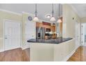 Open kitchen design featuring stainless steel appliances, granite countertops, and a breakfast bar at 1984 Folly Rd # A306, Charleston, SC 29412