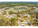 Picturesque aerial view showcasing the community's lush landscaping, serene ponds, and recreational amenities at 2036 Yaupon Way, Johns Island, SC 29455