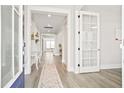 Inviting foyer with an open layout, featuring hardwood floors, natural light, and modern decor at 204 Corvus St, Summerville, SC 29483