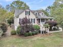 Inviting two-story home showcasing a lush front yard, a cozy porch, and well-maintained landscaping at 2093 Rookery Ln, Charleston, SC 29414