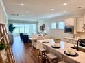 Open-concept kitchen flows into the living area, featuring hardwood floors and natural light at 214 Garden Gate Way, Summerville, SC 29486