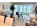 Bright living room features neutral furniture, area rug, and large windows at 214 Garden Gate Way, Summerville, SC 29486