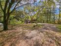 Inviting exterior showcasing a charming home surrounded by mature trees and a spacious yard at 217 Brick Rd, Walterboro, SC 29488